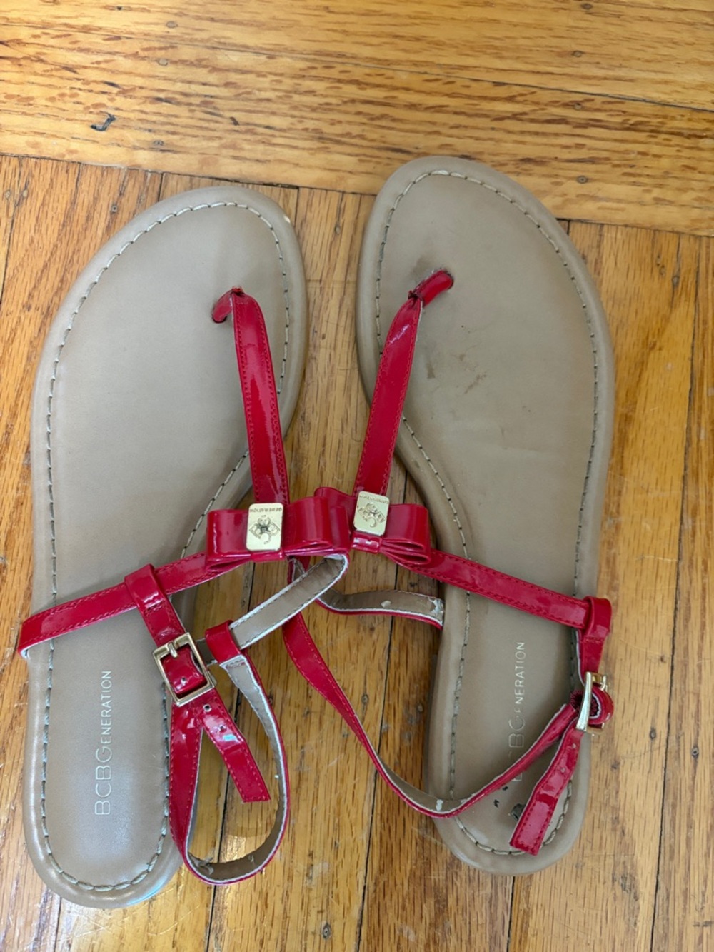 BCBGeneration Red Patent Bow T-Strap Sandals with Gold Accents